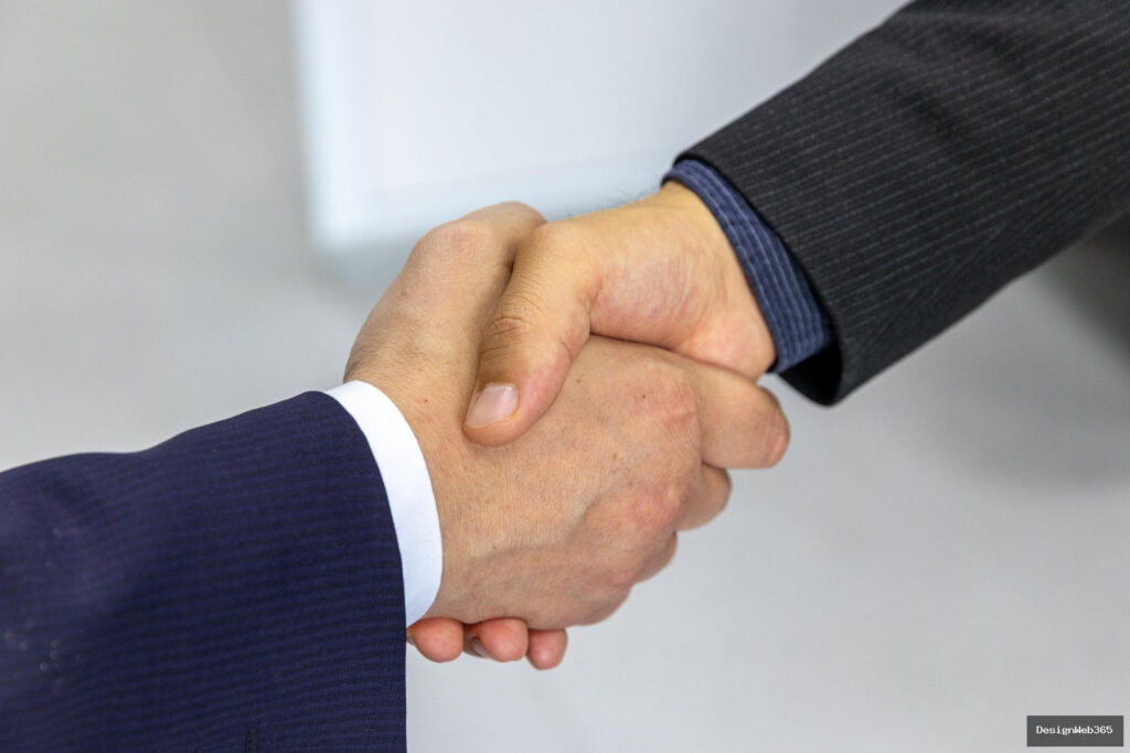 Poignee de main entre deux professionnels, symbole d'accord et de partenariat